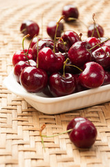 Fototapeta na wymiar Fresh cherries in bowl on table