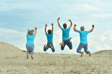 Grandparents with grandchildren jumping