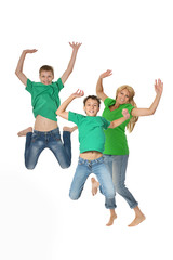 Mother and sons jumping in studio