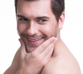 Obraz premium Smiling young man with hand near the face.