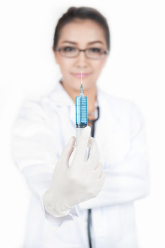 confidence female doctor holding and seeing an syringe