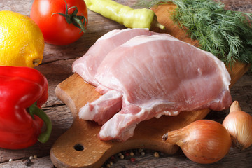 raw pork meat closeup and fresh vegetables horizontal