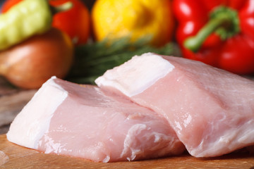 raw pork meat close up on a background of vegetables