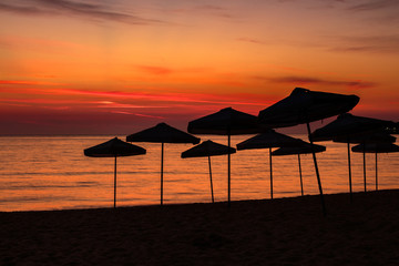 beach umbrellas silhouettes at dawn