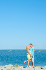 Fototapeta na wymiar Picture of romantic young couple by the sea. Space for text.