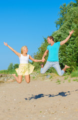 Happy young couple having fun on the beach.