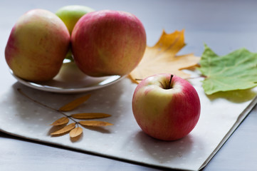 Apples with autumn leaves on the napkin