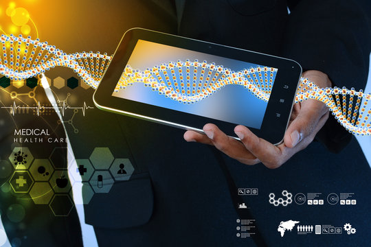Smart hand showing tablet pc with DNA interface