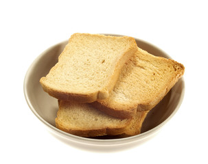 Rusks in bowl, isolated on white background