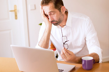 businessman falling aslepp at his desk