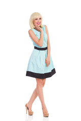 Smiling woman in light blue color dress