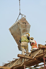 Two construction workers casting beam