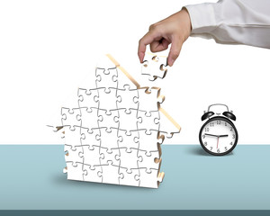 hold the last piece of house puzzle with clock