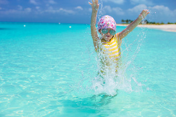Happy little girl have fun at beach during caribbean vacation