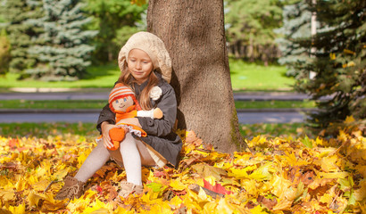 Cute little girl at warm sunny autumn day outdoor