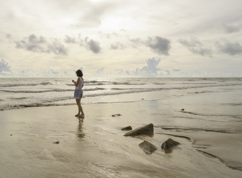 Asain woman stand on the beach
