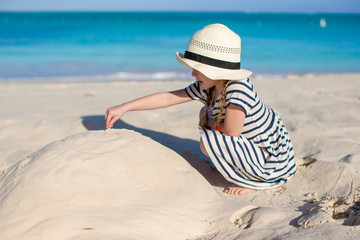 Little cute girl in hat at beach during caribbean vacation