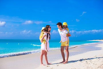 Happy family of four on caribbean holiday vacation