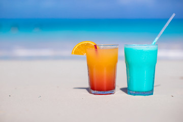 Close up Blue Curacao and Mango cocktail on the white sandy
