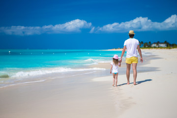 Happy father and his cute little daughter at beach