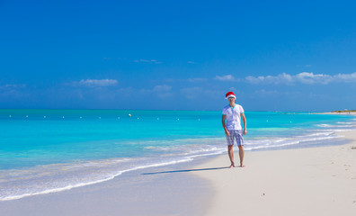 Young man in santa hat during beach vacation