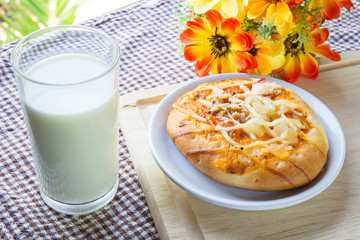 Pizza with crab and milk on table
