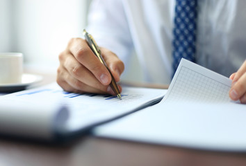 Businessman taking business notes at office