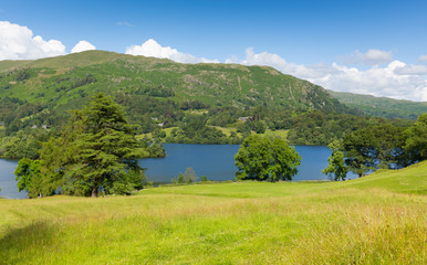 Fototapeta na wymiar Grasmere Lake The Lakes Cumbria England UK with blue sky