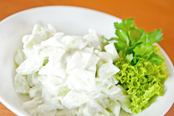 Salad with cucumber and garlic sour cream sauce