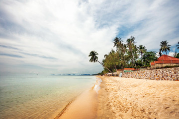 Exotic tropical beach under gloomy sky
