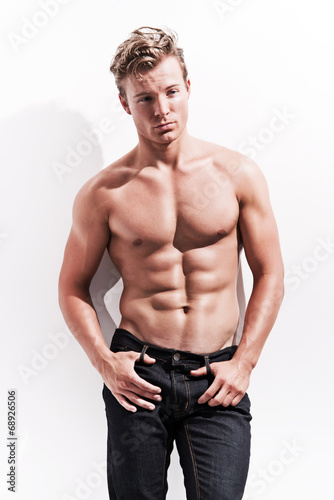 Male Fitness Model Wearing Blue Jeans Blonde Hair Against Whit
