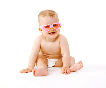 Stylish smiling baby in pink glasses