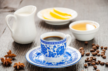 espresso in blue cup with lemon and honey on table