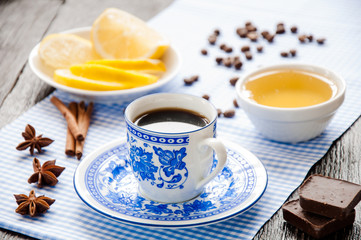 espresso in blue cup with lemon and honey on table