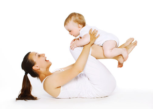 Mother and baby are doing exercise, gymnastics, fitness, play -