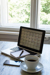 Checking monthly activities in the calendar in the laptop.