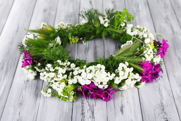 Wildflower wreath on grey wooden background