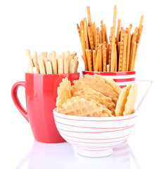Sticks and biscuits in red cup and white bowl
