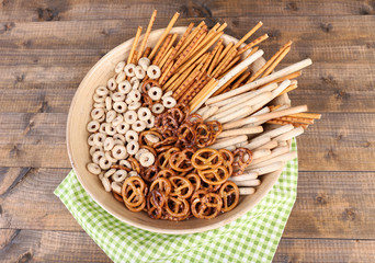 Dry breakfast, sticks and biscuits in a big wooden round bowl