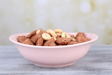 Dry breakfast in pink plate on wooden background