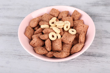 Dry breakfast in pink plate on wooden background