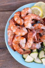 Plate of fresh boiled prawns with tomatoes, lettuce, lemon and
