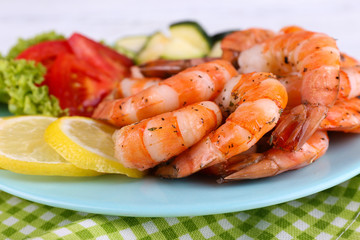 Plate of fresh boiled prawns with tomatoes, lettuce, lemon and
