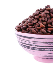 Coffee beans in big lilac bowl isolated on white