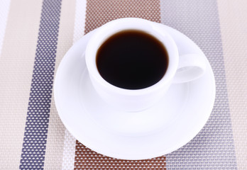 Cup of fresh hot coffee on table cloth