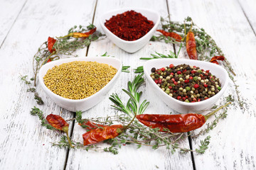Spices in glass round bowls with herbs and chilly pepper