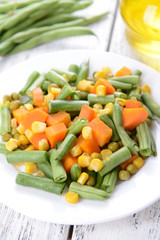 Delicious vegetables salad on plate on table close-up
