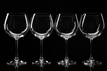 Empty wine glasses isolated on black
