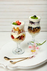 Natural yogurt with fresh berries on wooden table