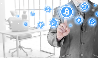 Choosing bitcoins, businessman pressing touch screen button.